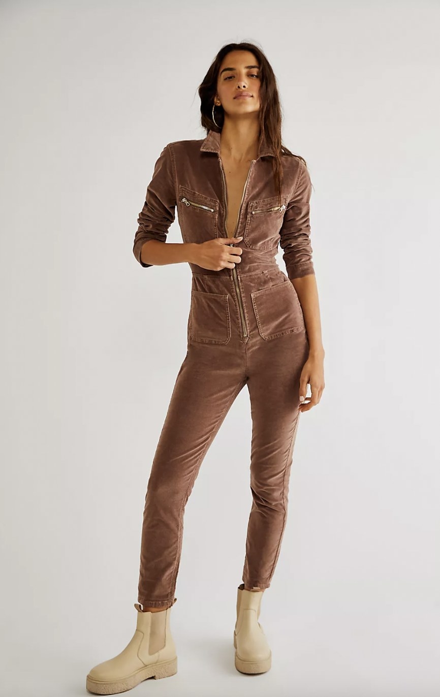 A woman wearing a brown corduroy jumpsuit with tan boots