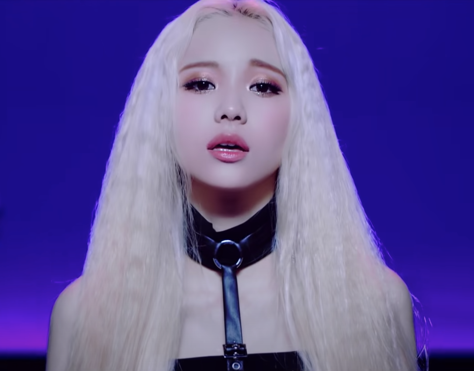 JinSoul sings to the camera, a pleading expression in her eyes