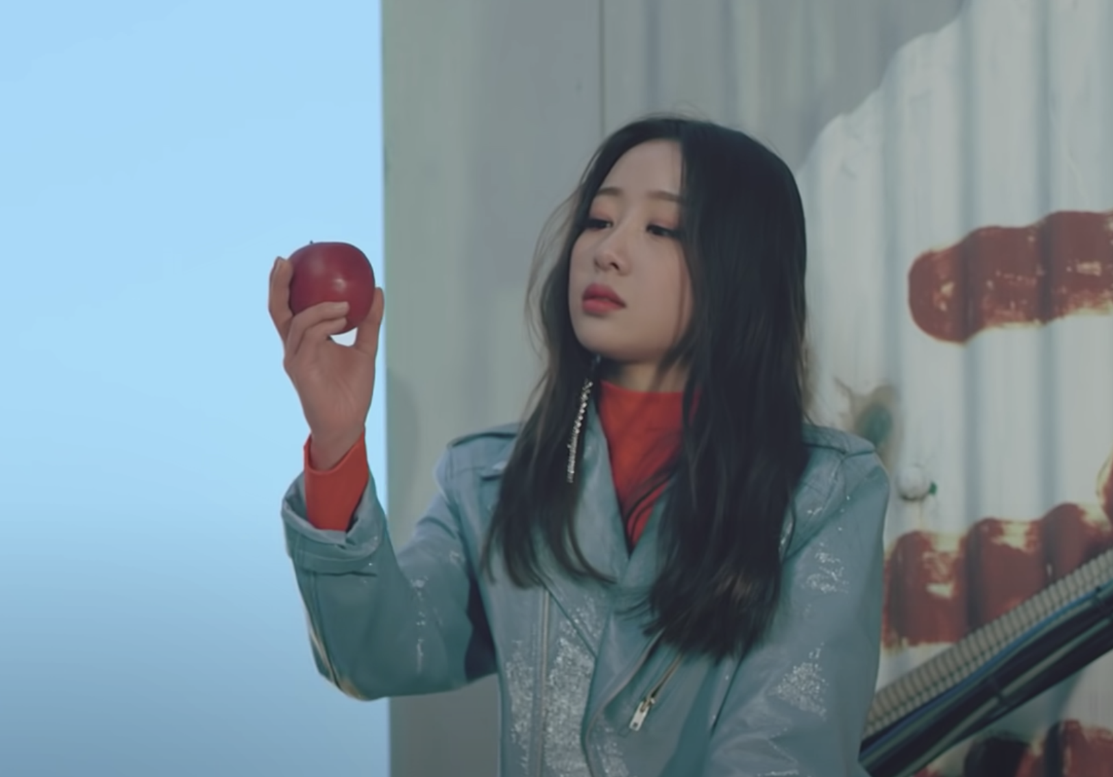 Yves holding out an apple in front of her