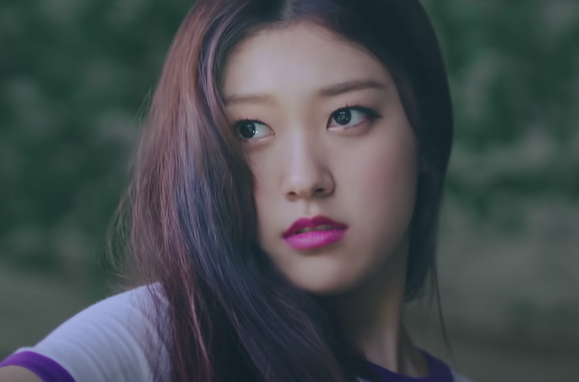 Choerry stands outside in a field and looks on