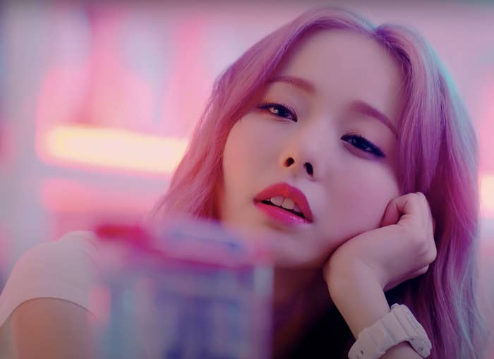 ViVi stares out dreamily and rests her hand on her head