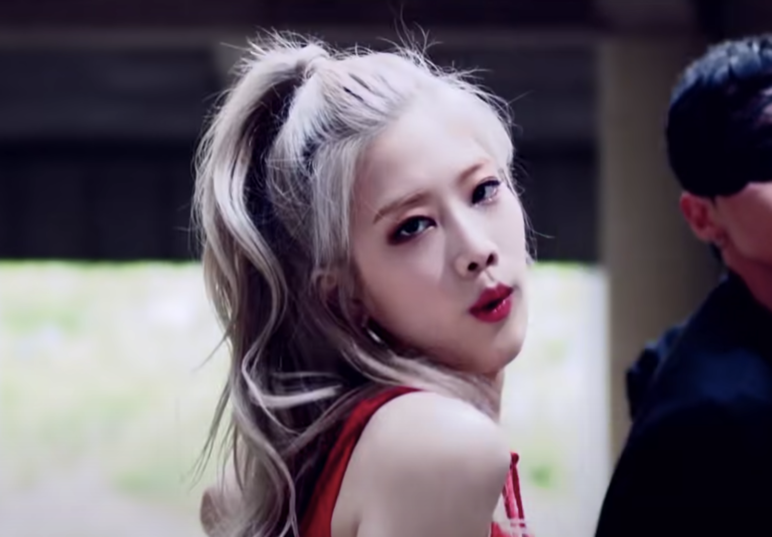 Kim Lip sings into the camera with a sultry look in her eyes and pouty lips