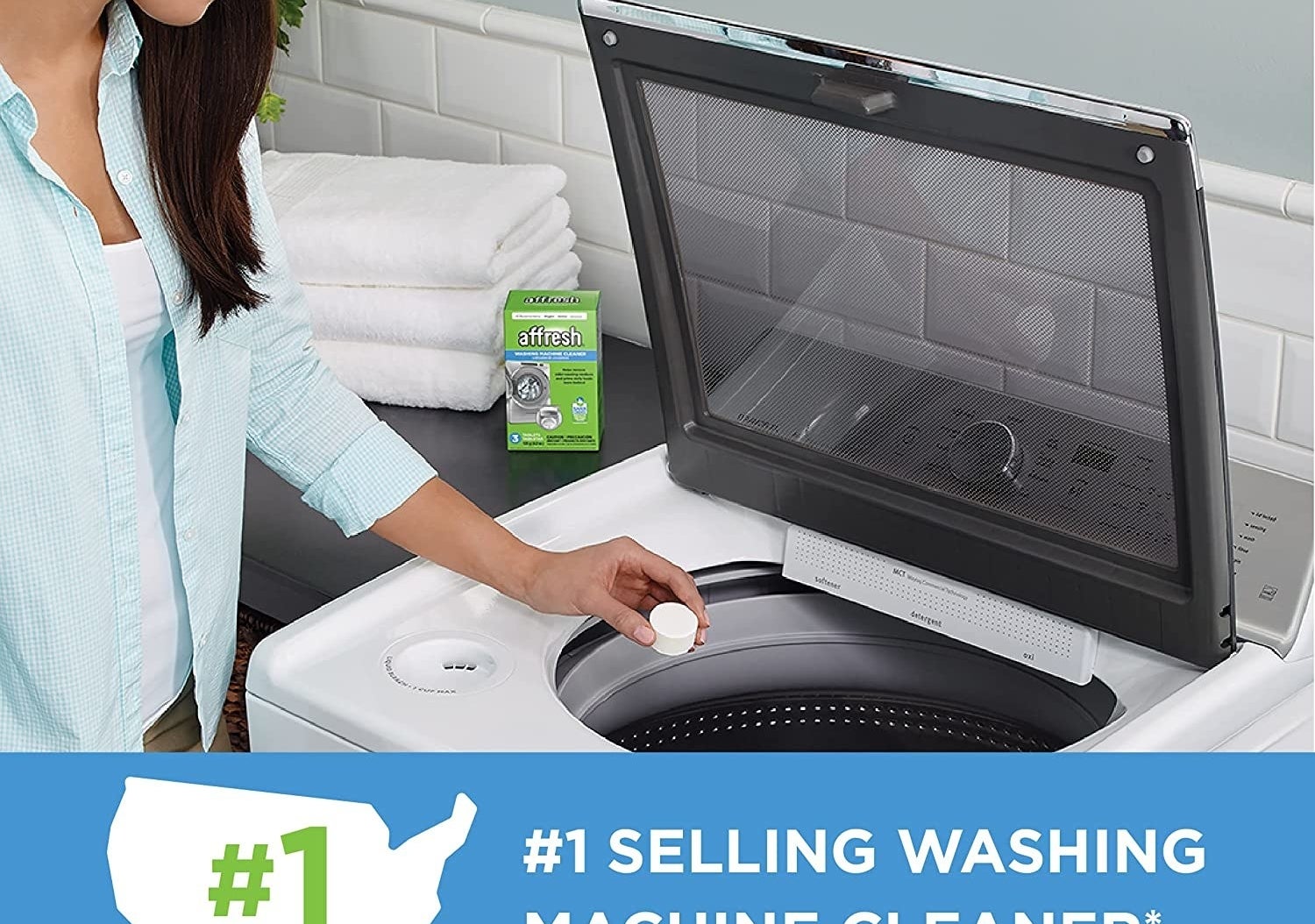 models hand dropping 1/4c-ish size tablet into washer