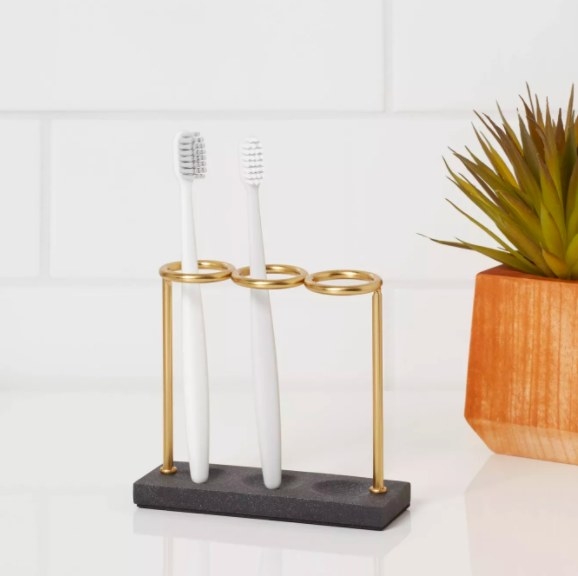 Gold and black toothbrush holder