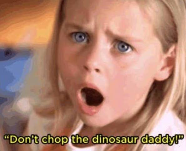 A young girl with her mouth open in shock; it is captioned "Don't chop the dinosaur daddy!"