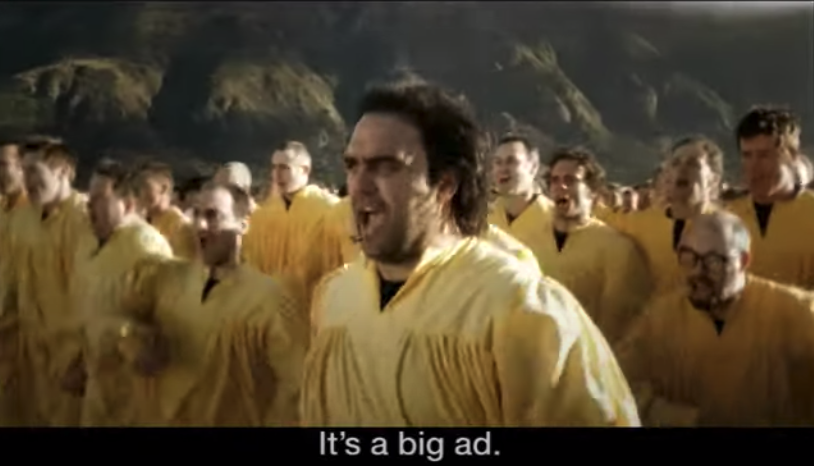 An army of people dressed in yellow robes marching together; it is captioned &quot;It&#x27;s a big ad&quot;