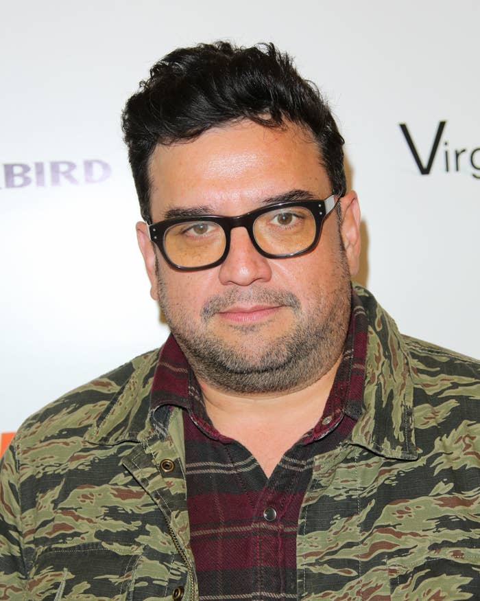Horatio Sanz at a red carpet event wearing glasses and a jacket and shirt
