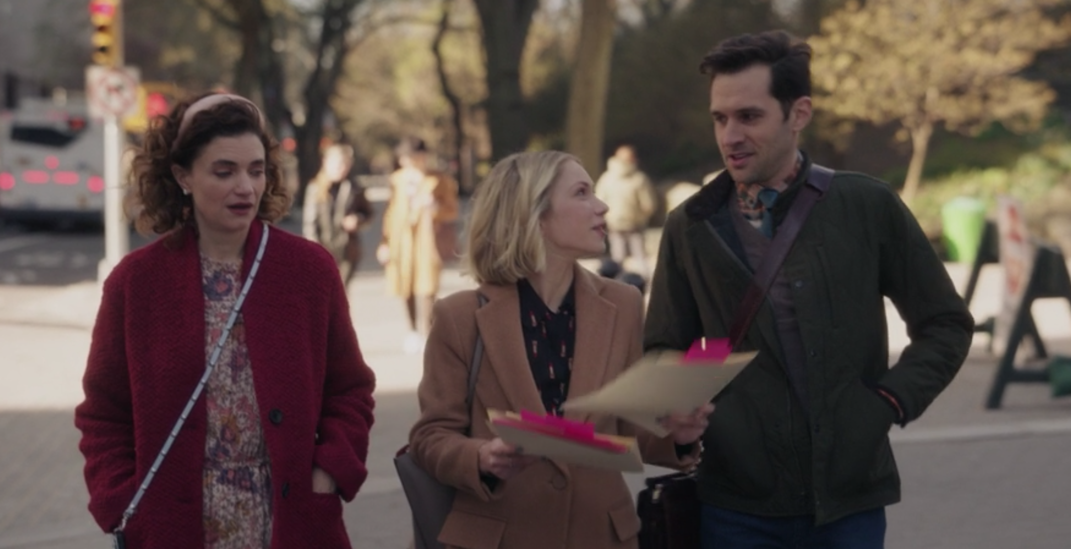 Wendy wears a floral dress under a peacoat, Kate wears a patterned blouse under a wool coat, and Jordan wears a V-neck sweater under a thin jacket