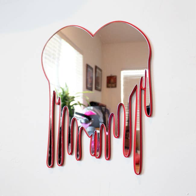 Red outlined mirror on white wall