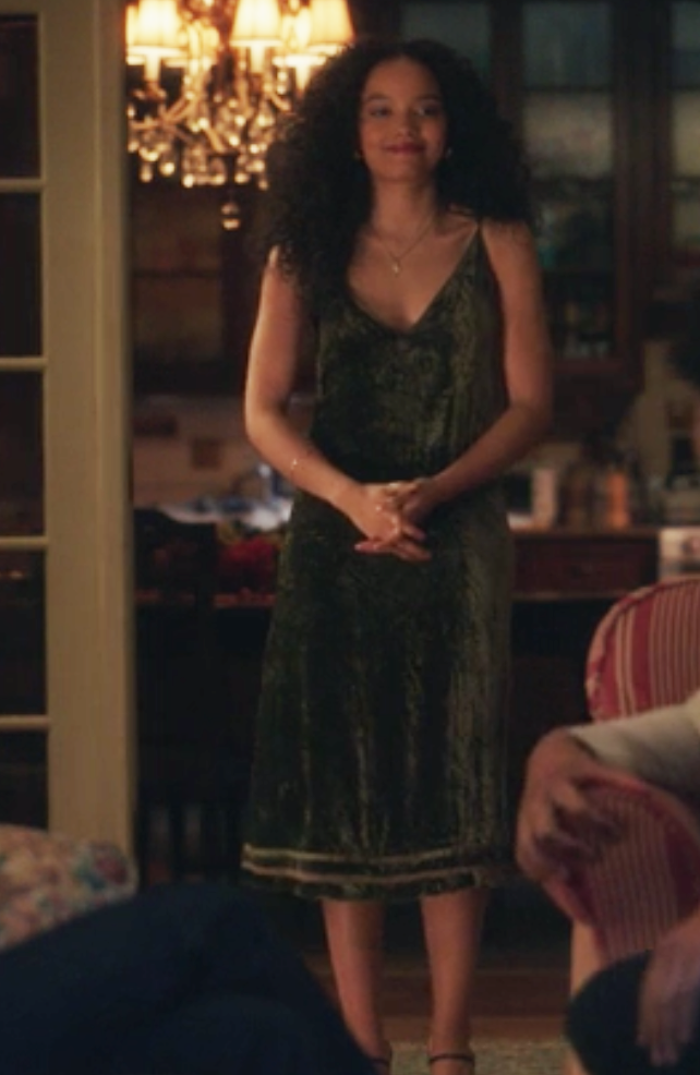 Zoya wears a knee length satin tank top dress