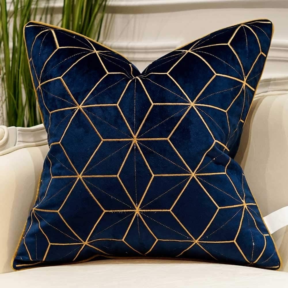 Blue and navy pillow on cream couch