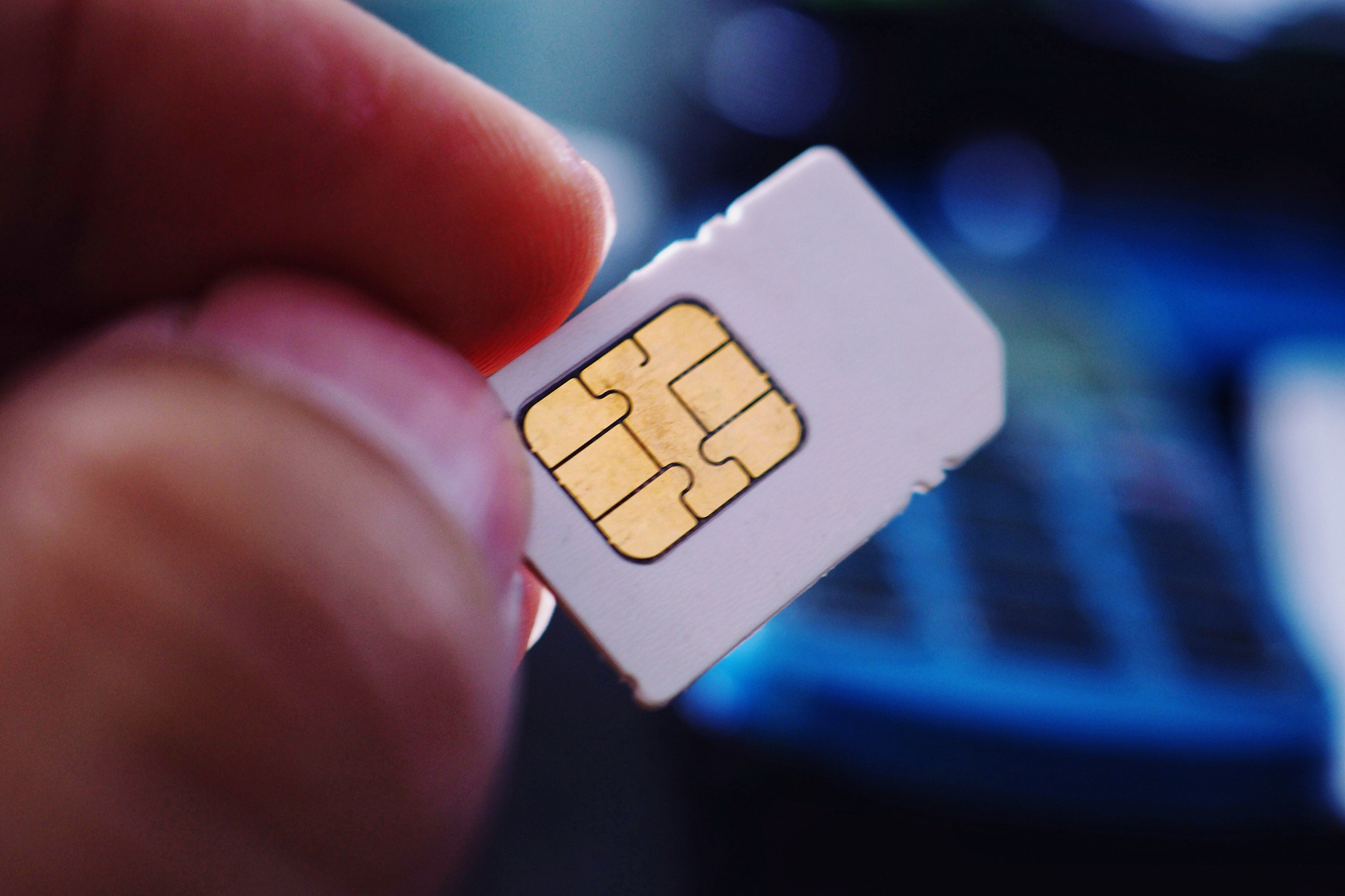 Someone holding a SIM card for a cellphone