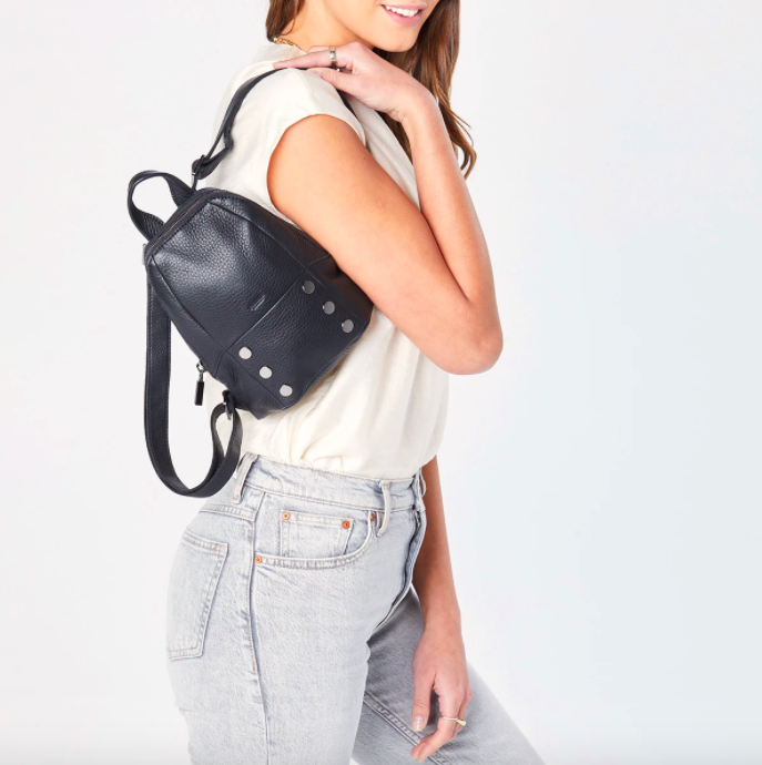 A model holding the backpack in black