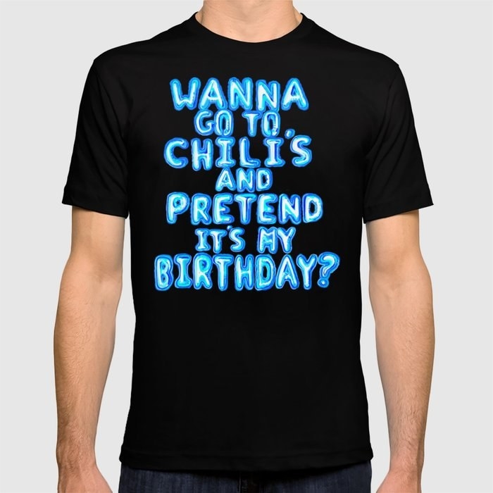 a model wearing a black shirt that says &quot;wanna go to Chili&#x27;s and pretend it&#x27;s my birthday?&quot;