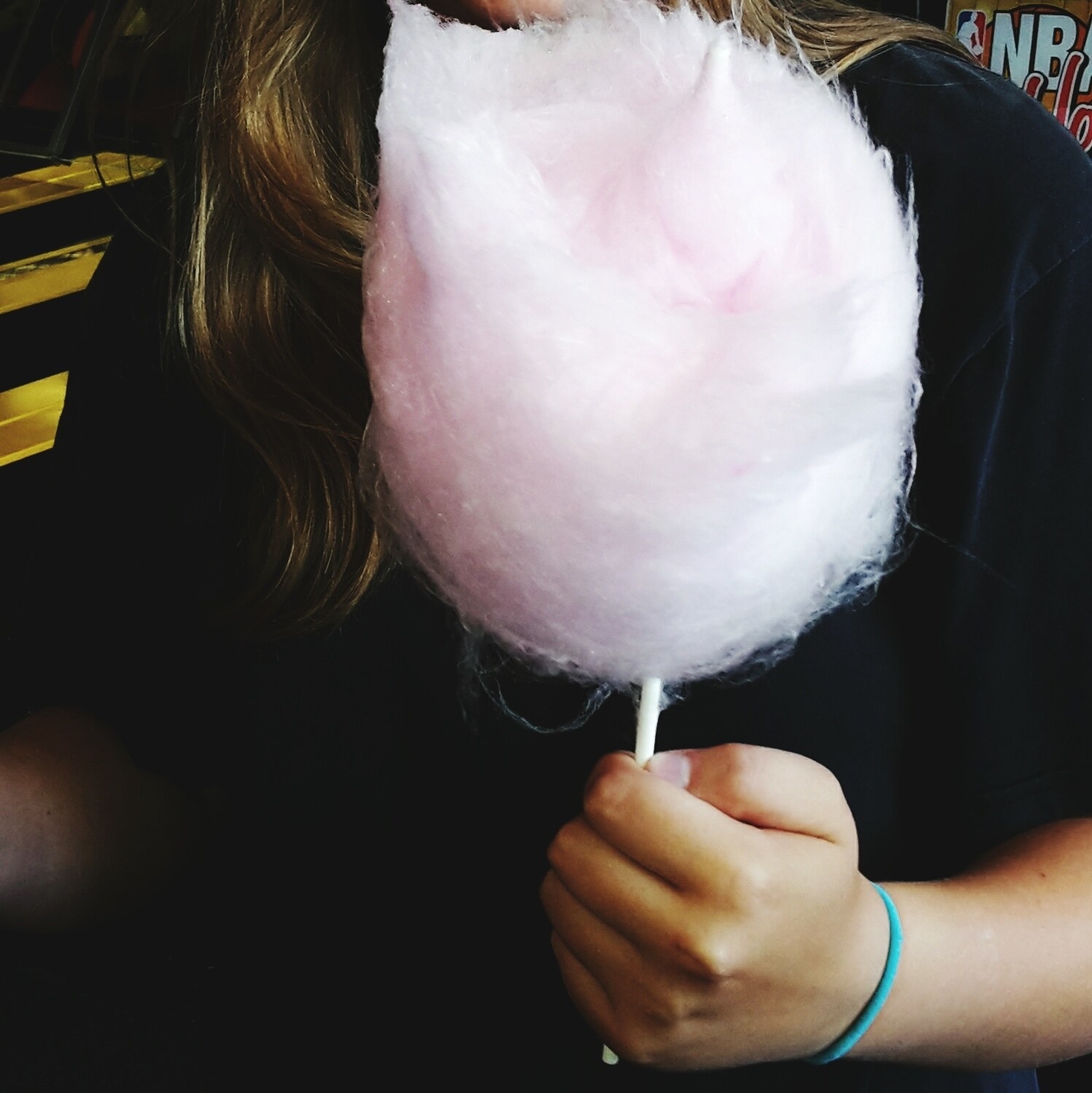 a girl eating cotton candy
