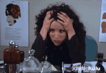 A stressed Elaine from &quot;Seinfeld&quot; grabs her hair in frustration