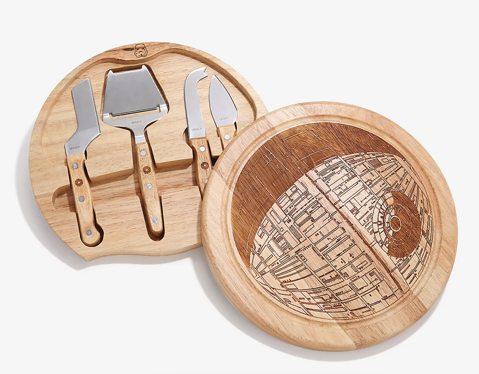 two-piece round wooden cheeseboard with print of the death star on one and an indented storage with four cheese cutting tools on the other
