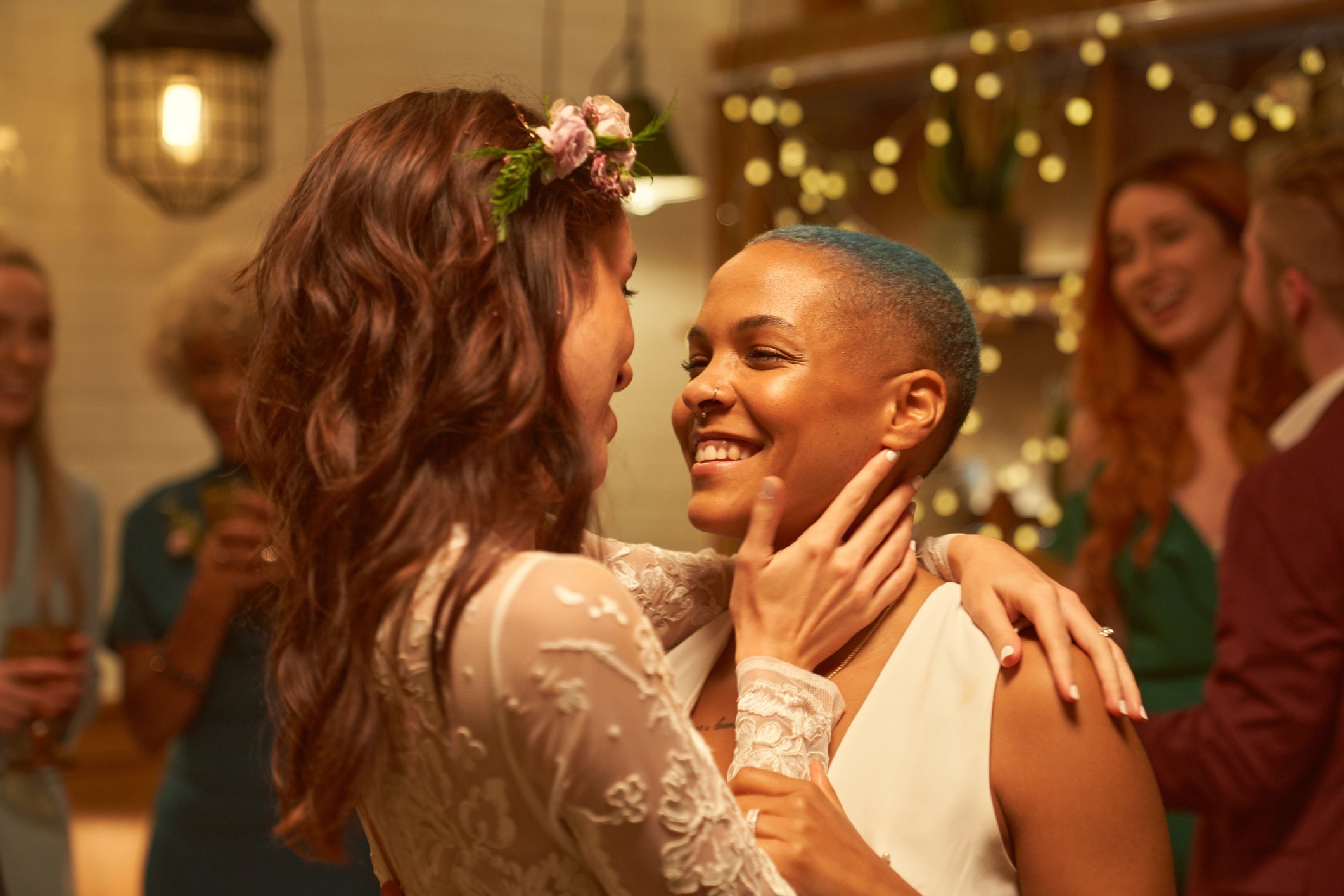 Two women embrace at their wedding party