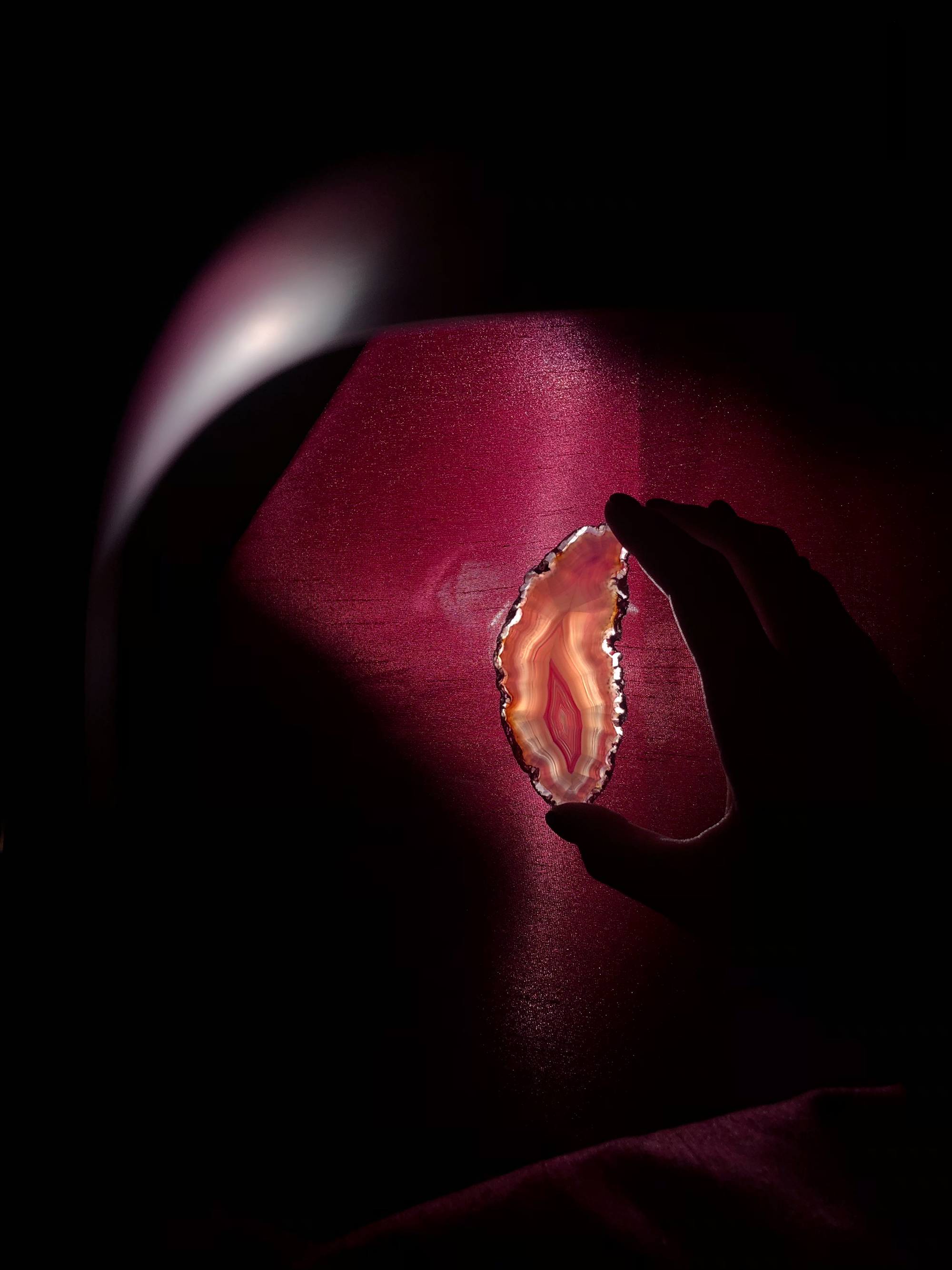 A slice of a crystal being held up to the light 