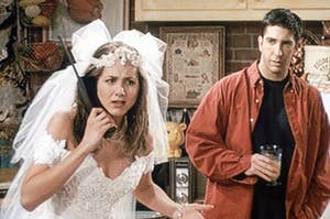 Rachel, while wearing a wedding dress, shouts into a landline phone as Ross stands behind her looking worried