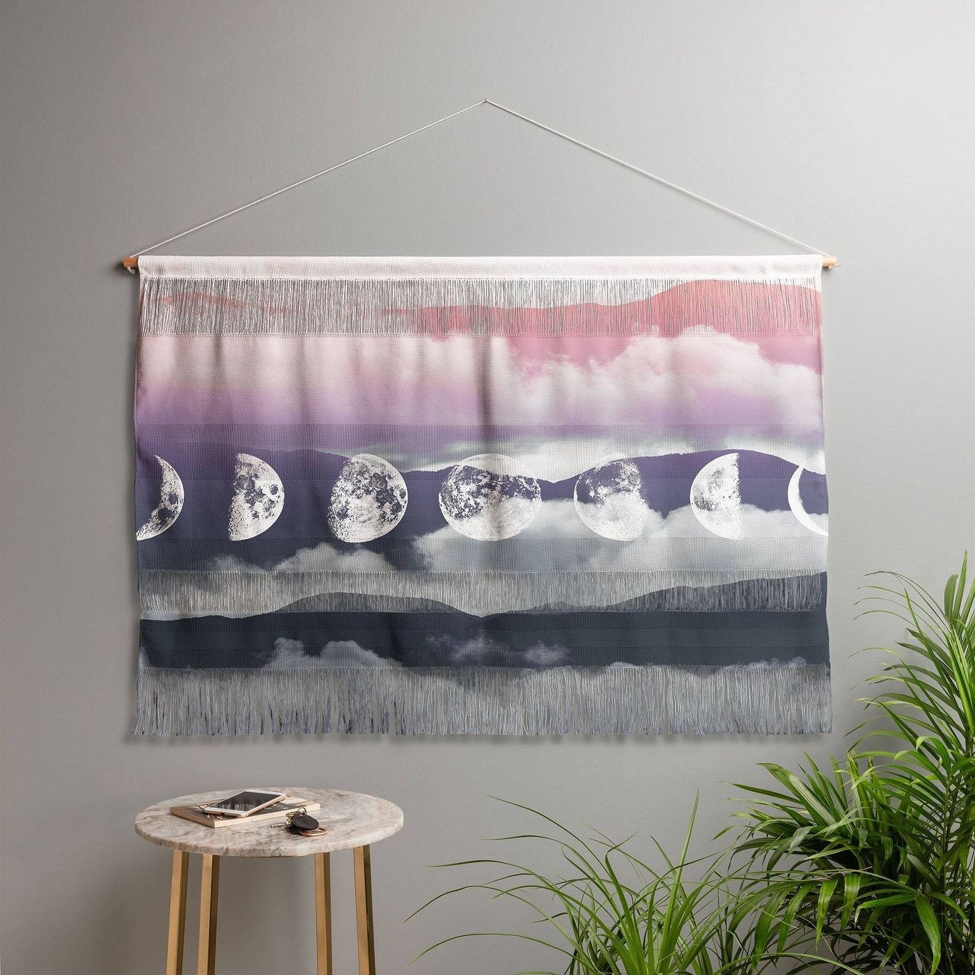 The tapestry hanging on a gray wall