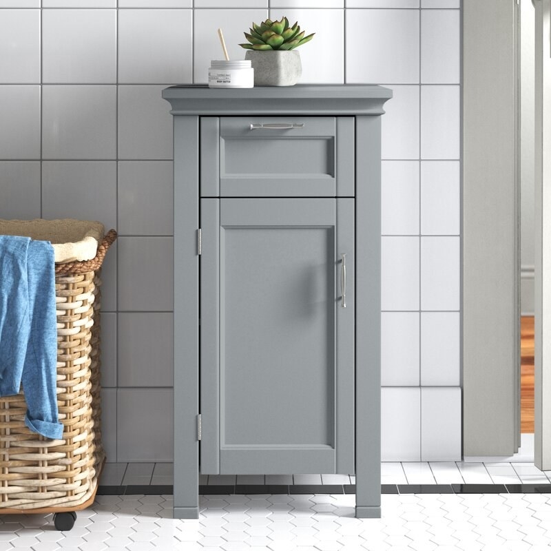 The cabinet in gray in a bathroom