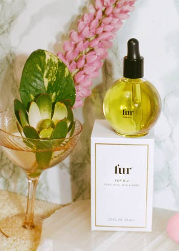Bottle of Fur Oil on box next to accessories