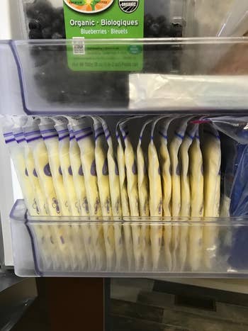 Reviewer's photo showing breastmilk stored in these compact storage bags in the freezer