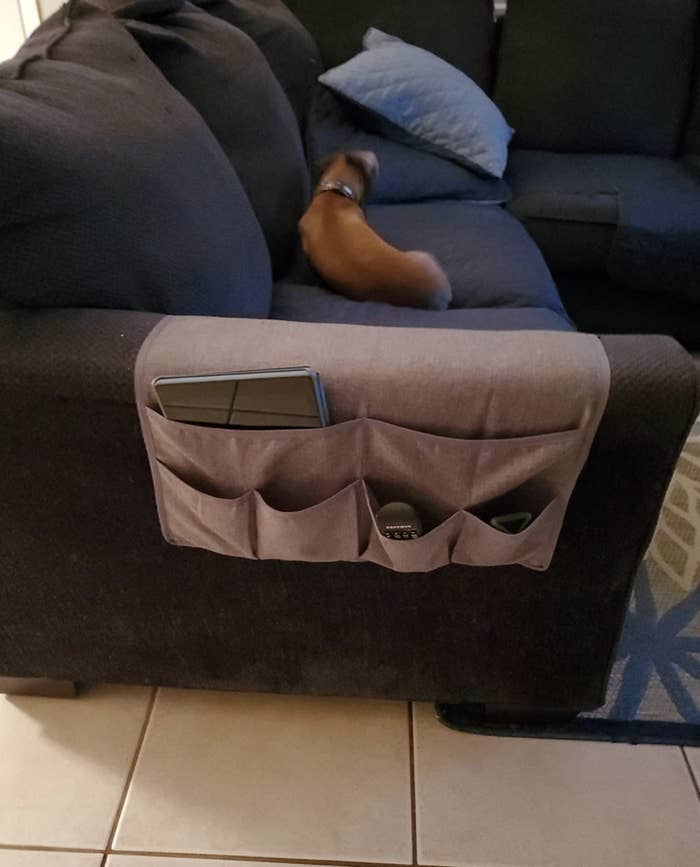 Reviewer's couch caddy placed over arm rest
