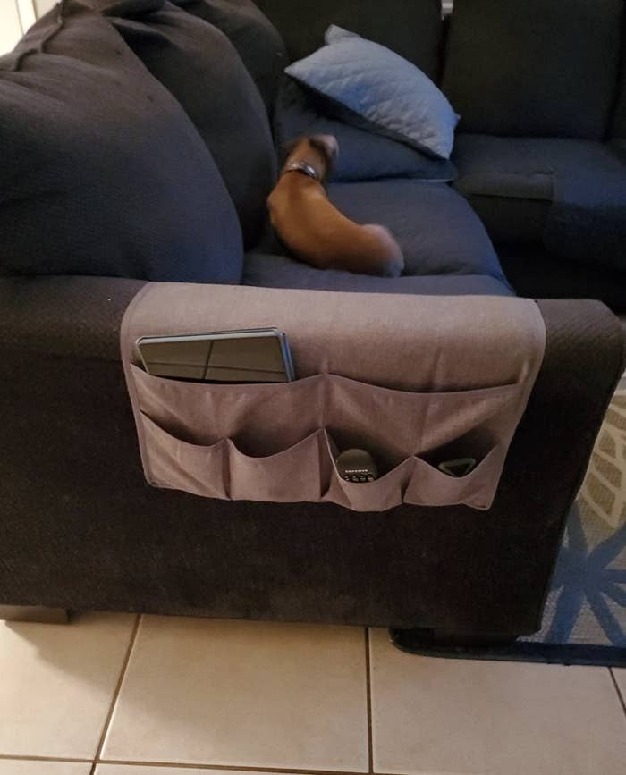 Reviewer&#x27;s couch caddy placed over arm rest