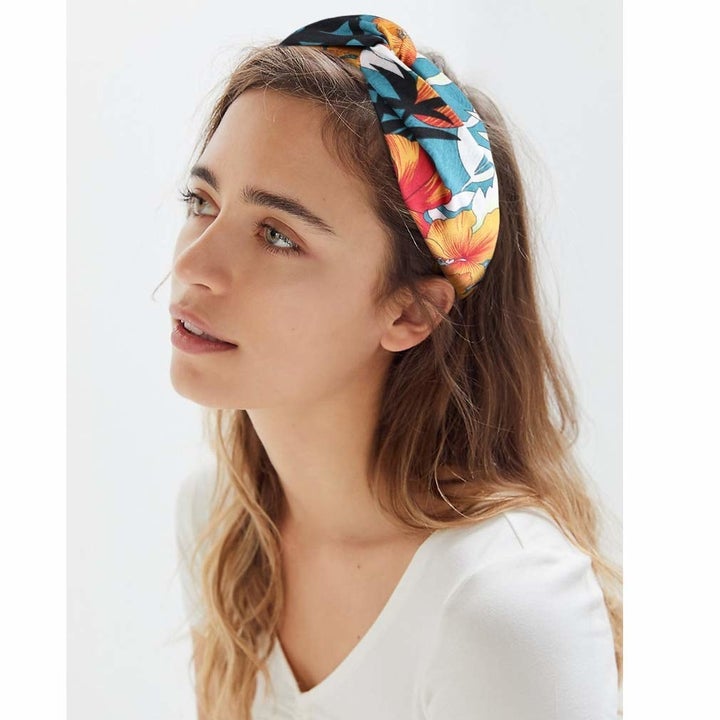 A model wearing a colourful head wrap