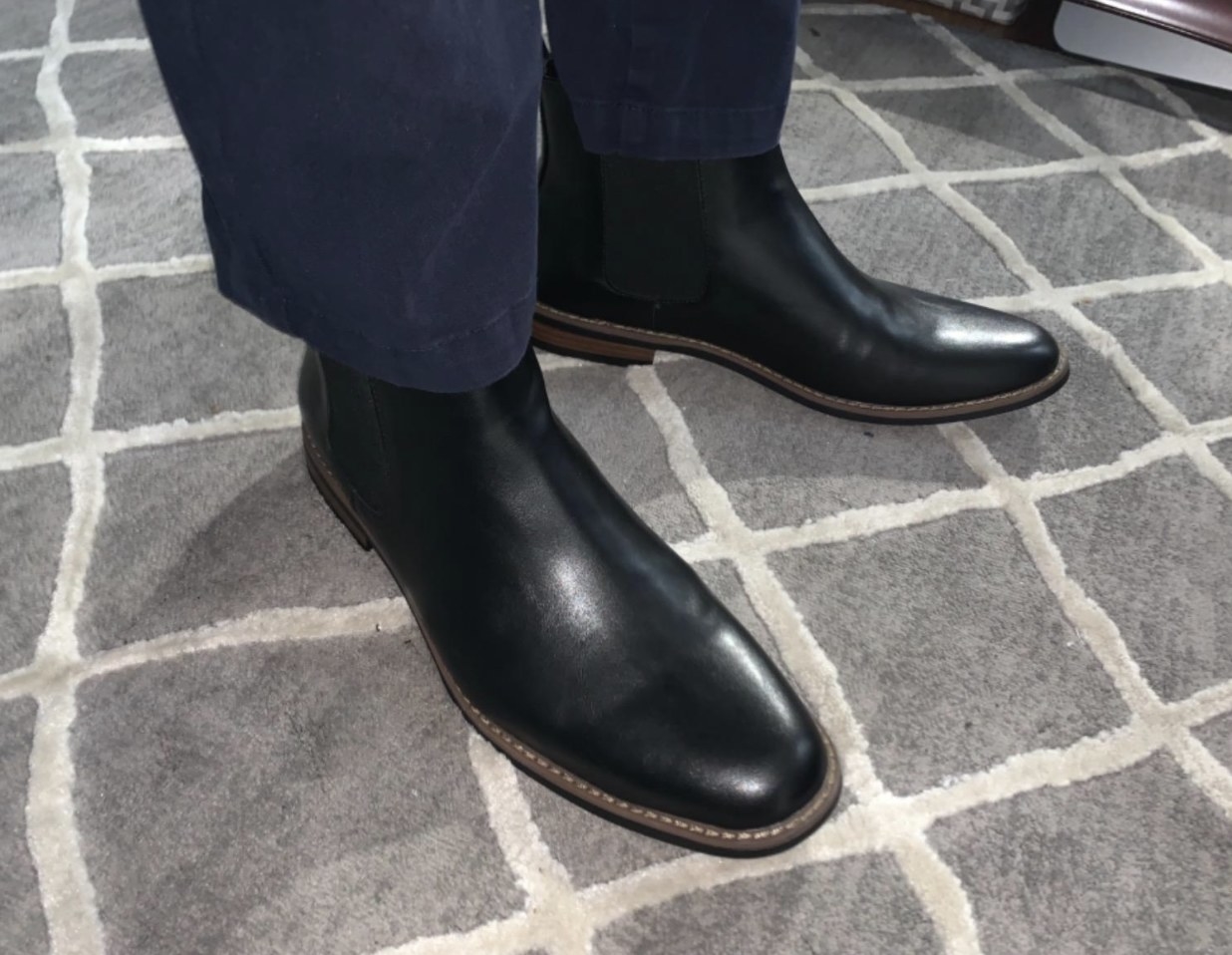reviewer wearing the boots in black with navy pants