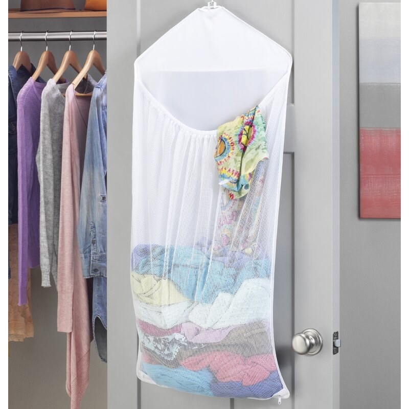 The overdoor laundry bag hanging with clothes inside