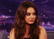 GIF of Mila shaking her head on a talk show