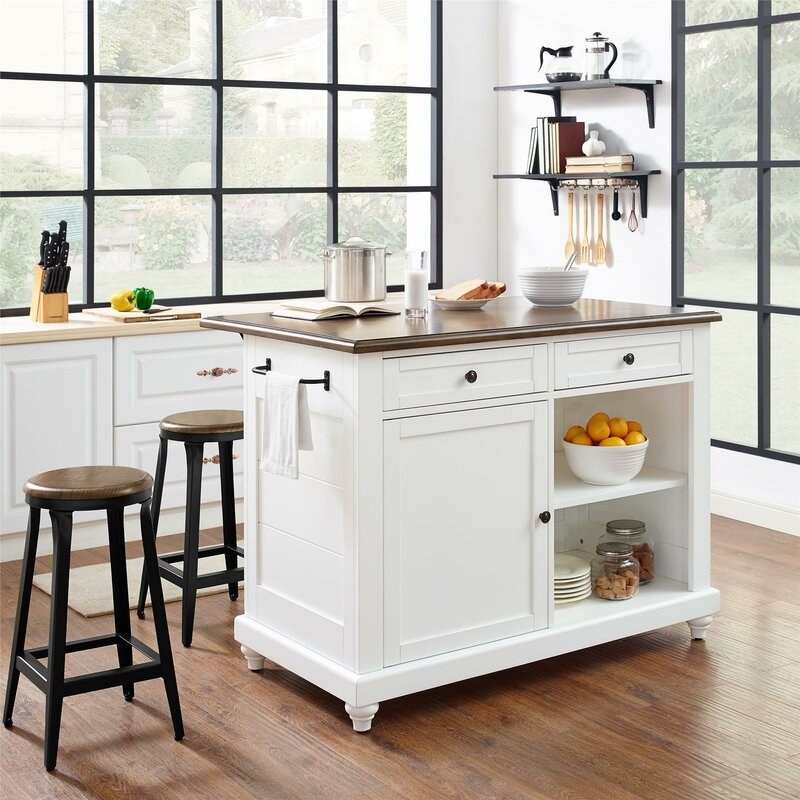 the kitchen island with stools in a kitchen