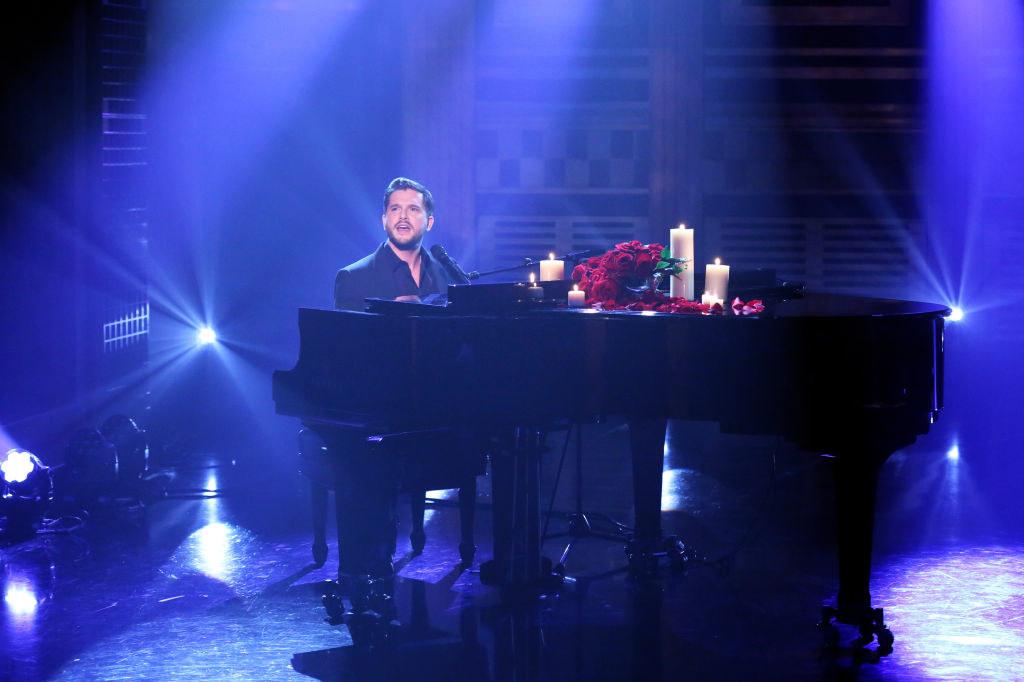 Kit at the keyboard, with candles on the piano