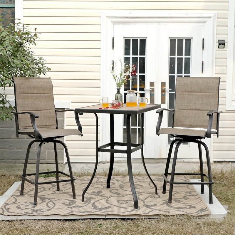 the two bar stools and table on a patio
