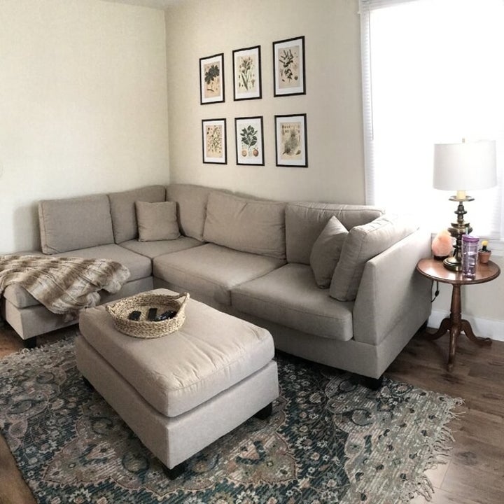 the sectional in a living room with matching ottoman