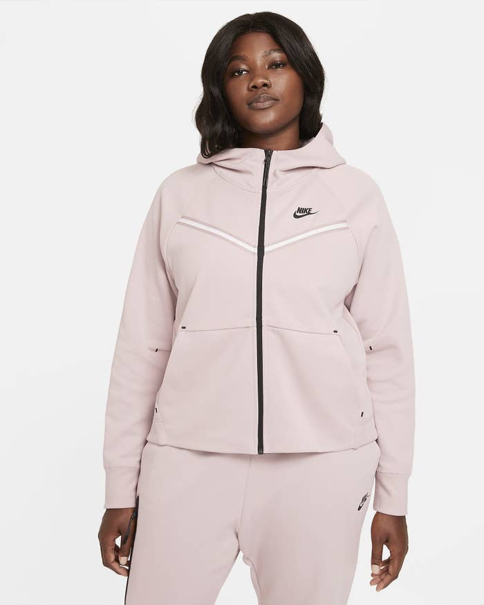 Model wearing pink wind runner jacket with matching pants