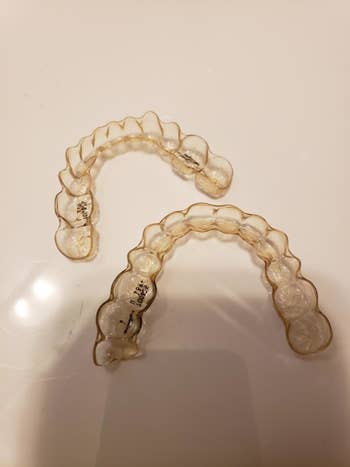 Reviewer's Invisalign, which look slightly yellow and stained