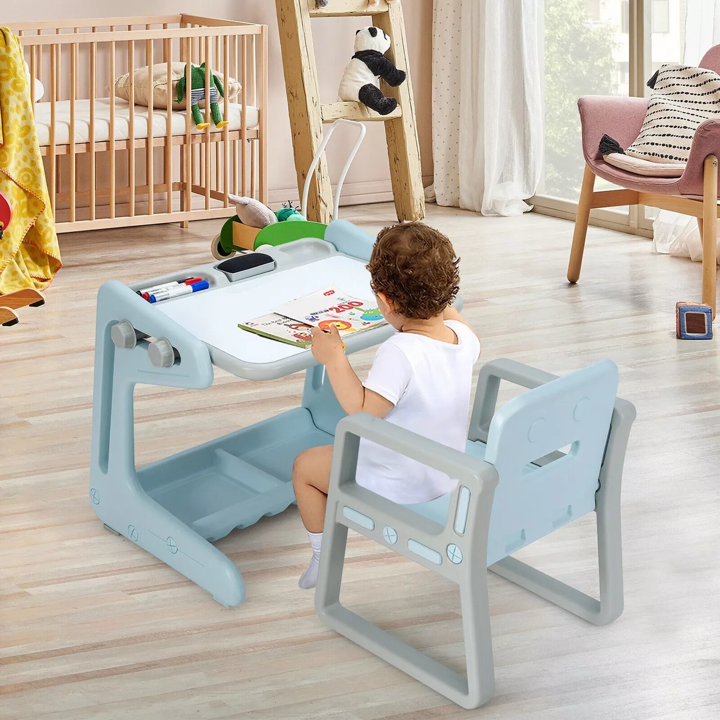 A child using the easel table in blue