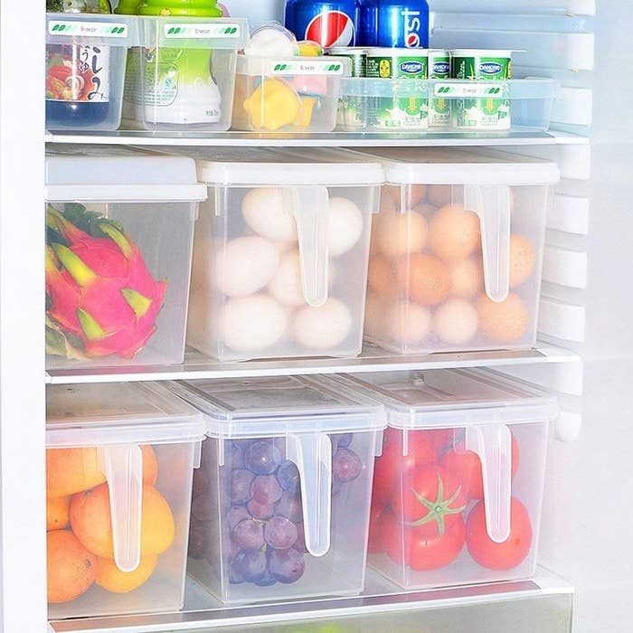 Produce containers in a fridge containing fruits and vegetables