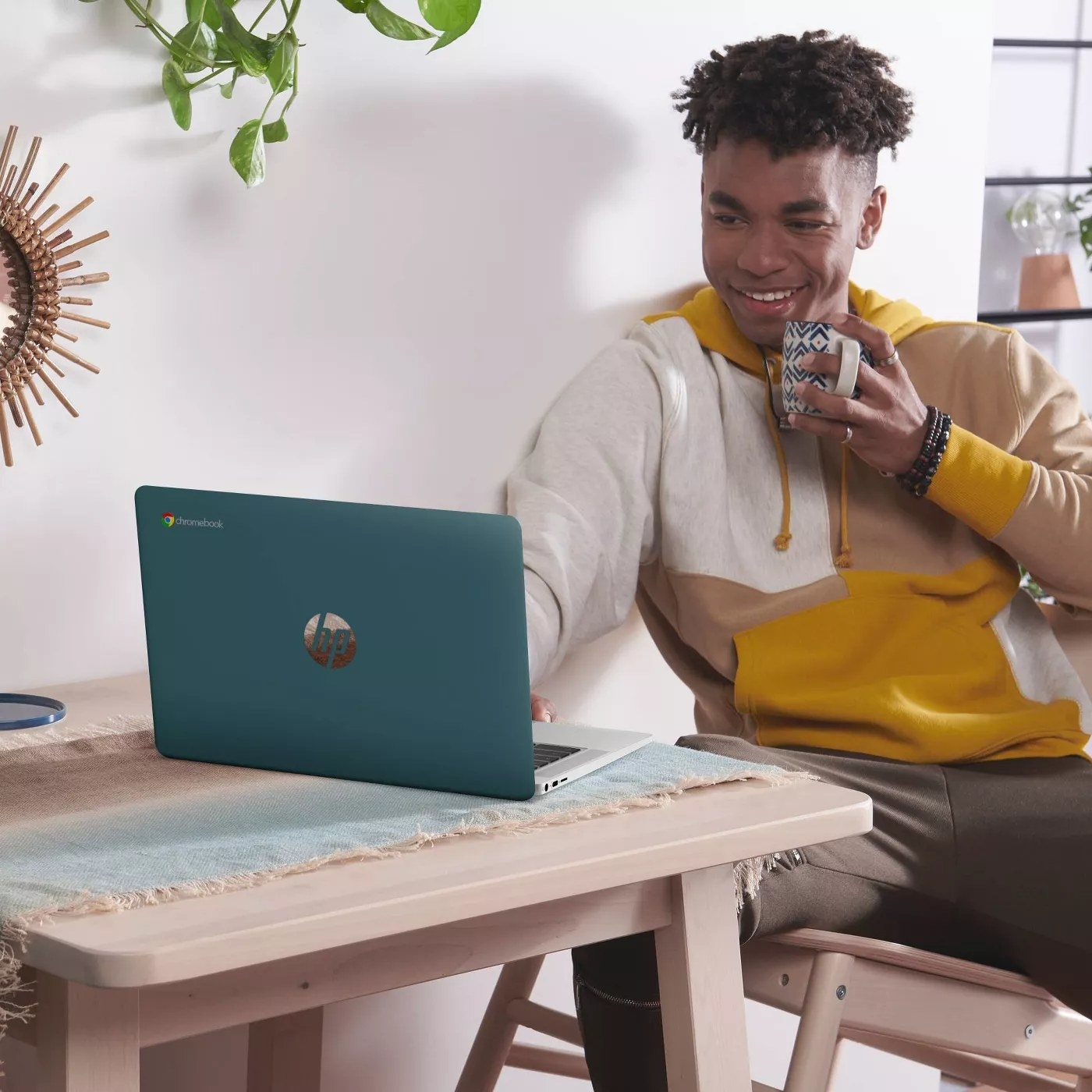 A model working at the teal HP laptop