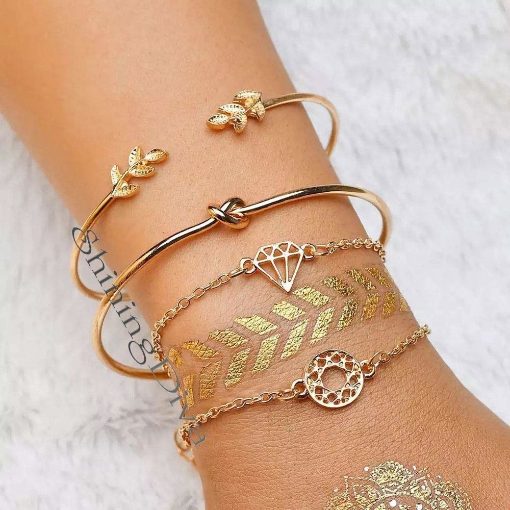 An arm wearing 4 layered gold-plated charm bracelets with a diamond, leaf, knot and circular designs