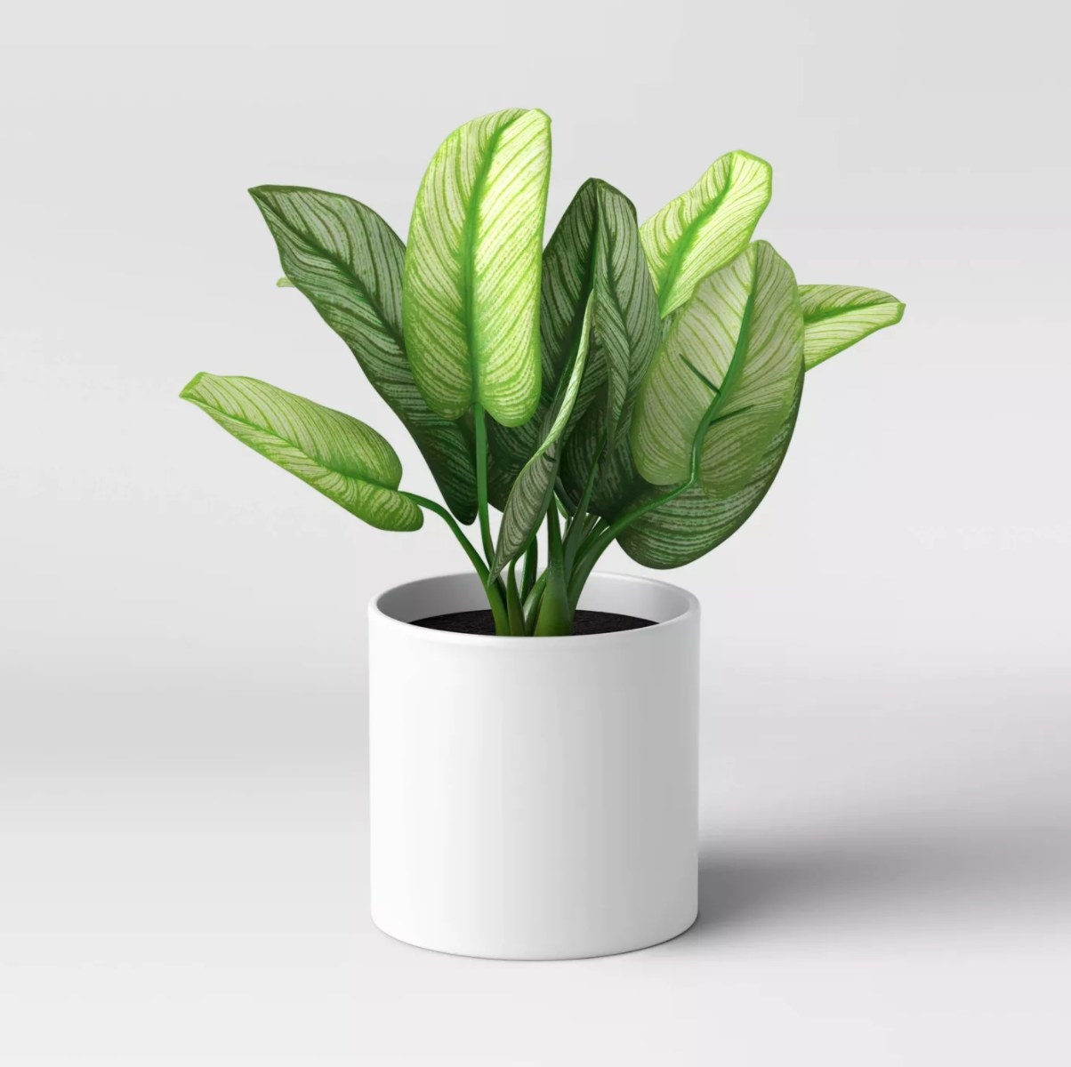 the artificial plant in a white pot