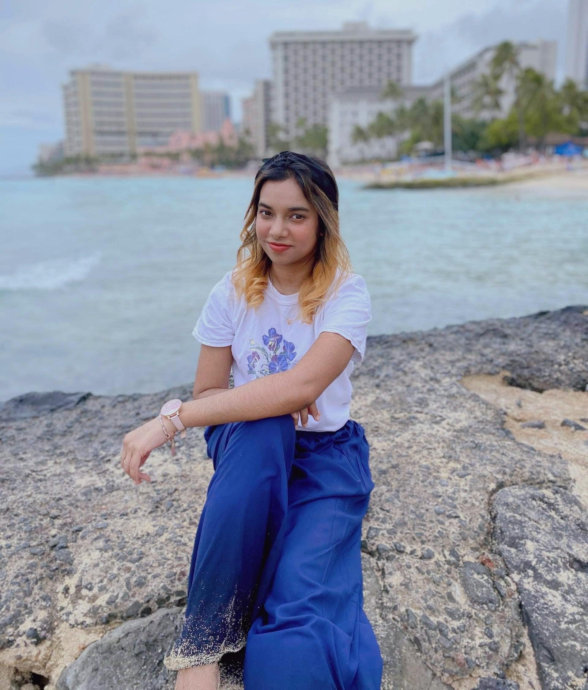 Nusrat posing on a beach