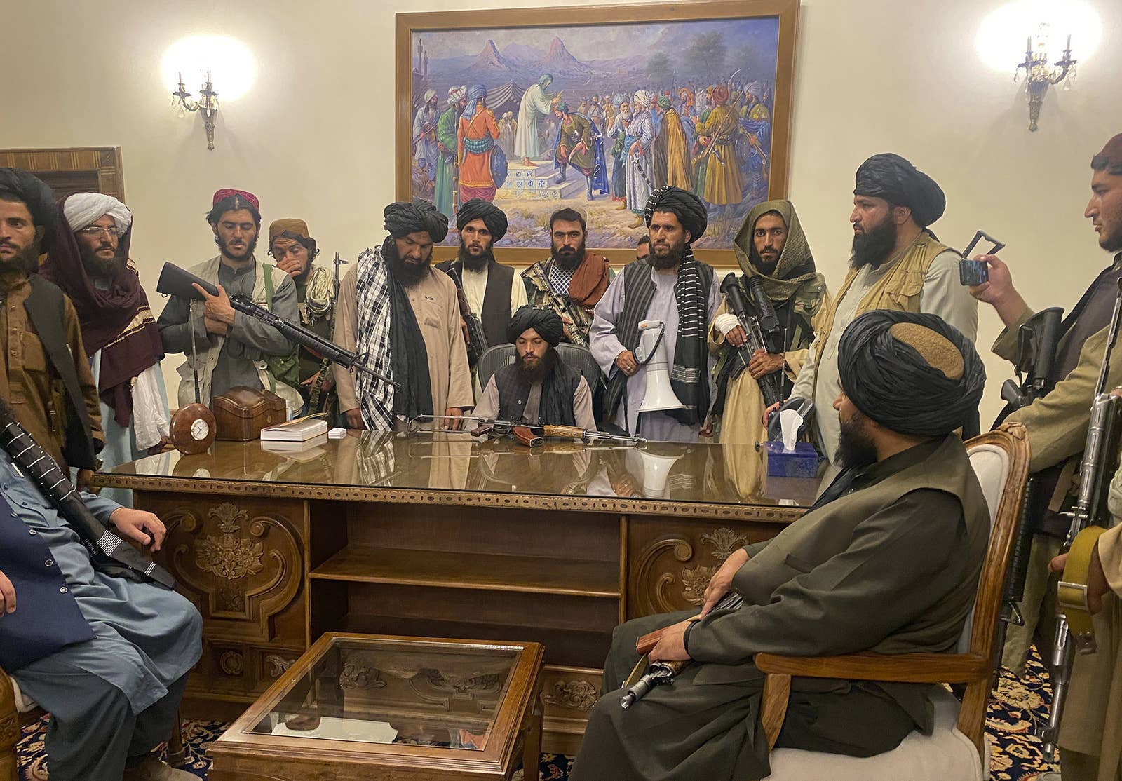 A group shot of Taliban fighters with guns at the presidential desk 