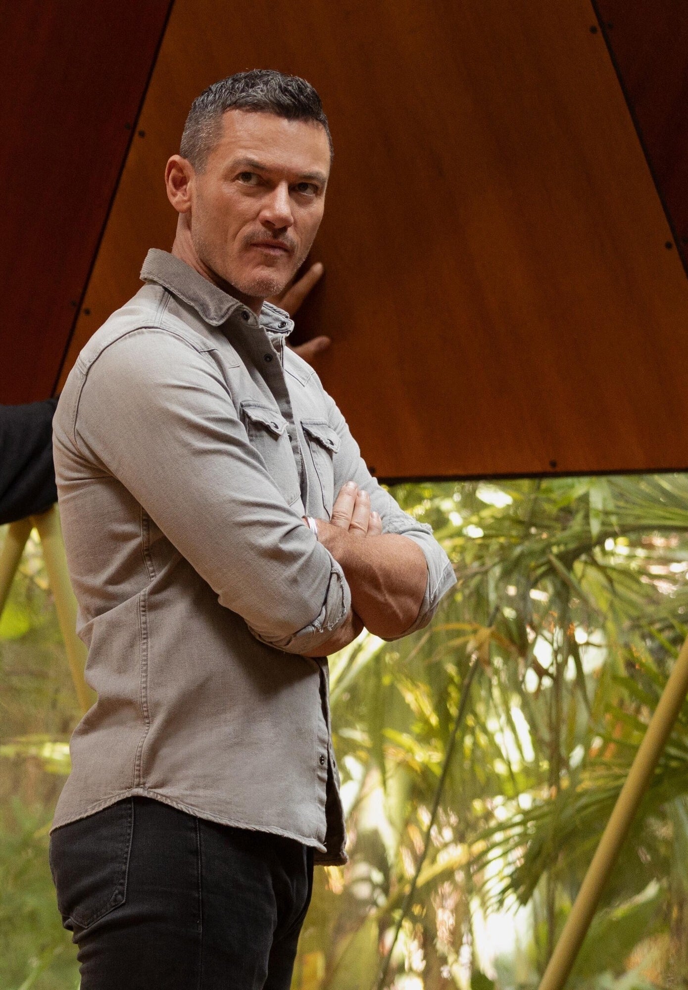 Luke Evans stands with his arms folded in the meeting room