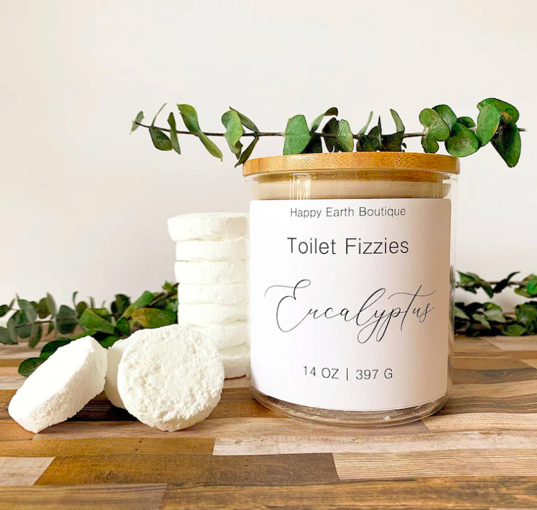 the white toilet fizzes in a circular shape sitting beside their jar which says &quot;Toilet Fizzies&quot; and &quot;Eucalyptus&quot; on the front