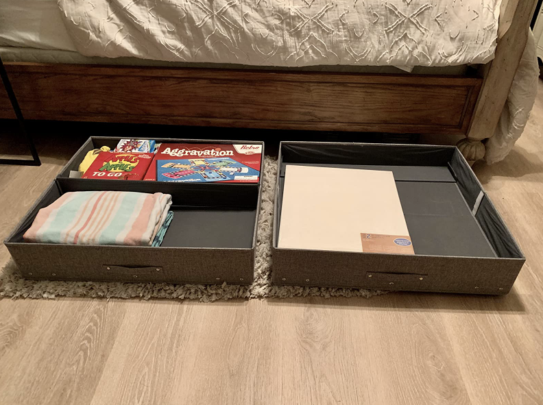 two bins holding board games and extra linens